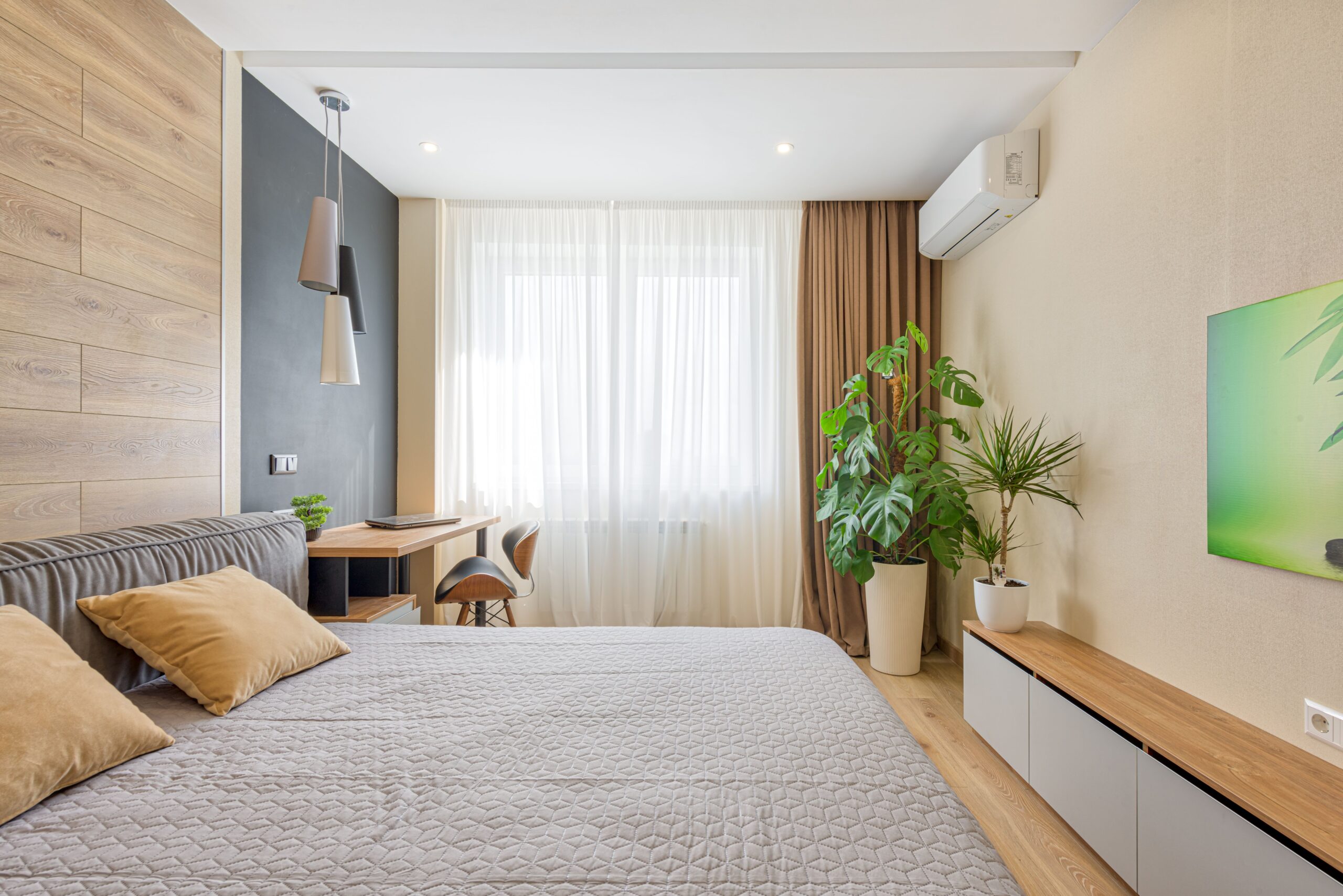 How To Choose The Perfect Curtains For Your Space A modern bedroom featuring cozy decor, natural light, and indoor plants.