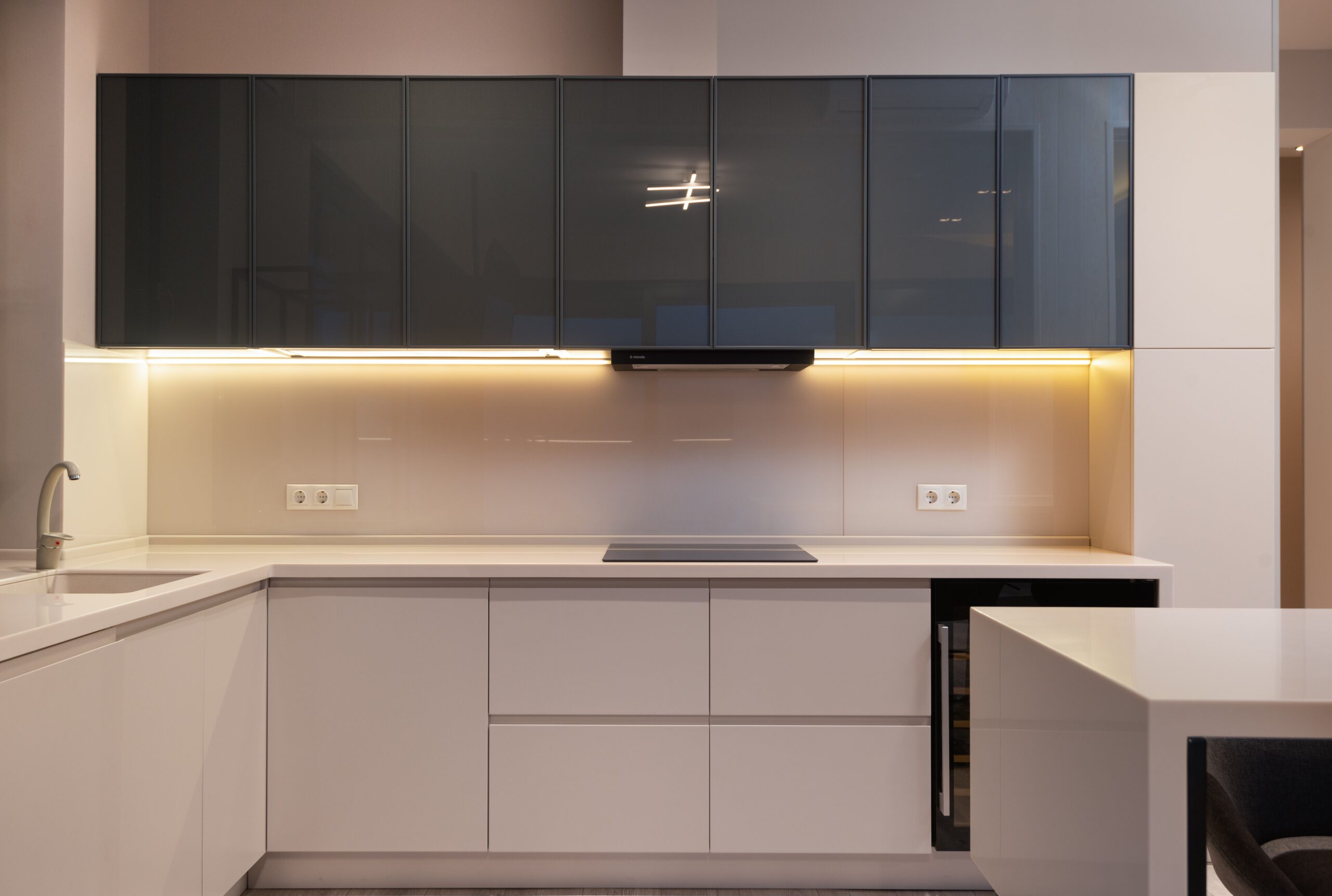 How To Master Lighting For A Cozy Bedroom Interior of modern light kitchen with minimalist furniture and illumination in spacious apartment
