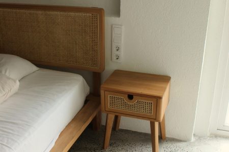 How To Choose The Perfect Nightstands For Your Bedroom Inviting minimalist bedroom with wooden bed frame and side table. Calm and serene.
